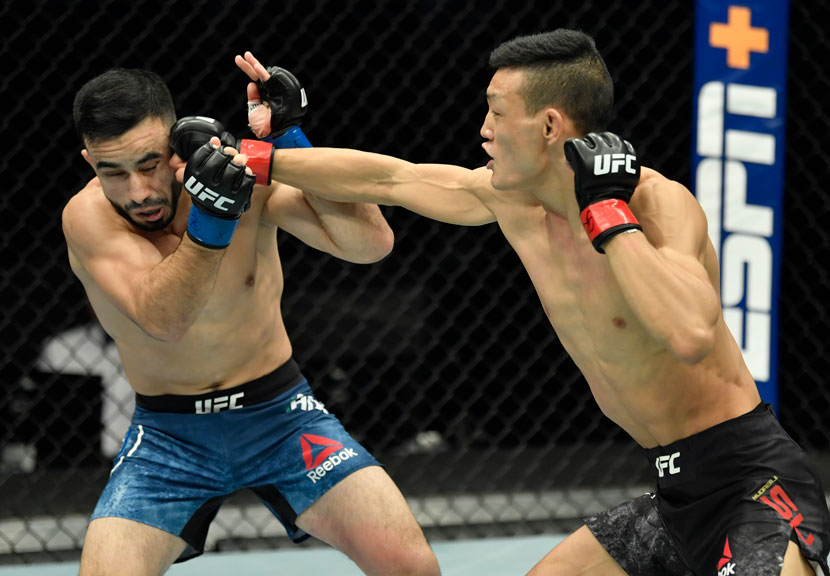 Su Mudaerji (right) punches Zarrukh Adashev of Uzbekistan during their flyweight bout at the UFC Fight Night event in Abu Dhabi, United Arab Emirates, Jan. 20, 2021. Jeff Bottari/Zuffa LLC